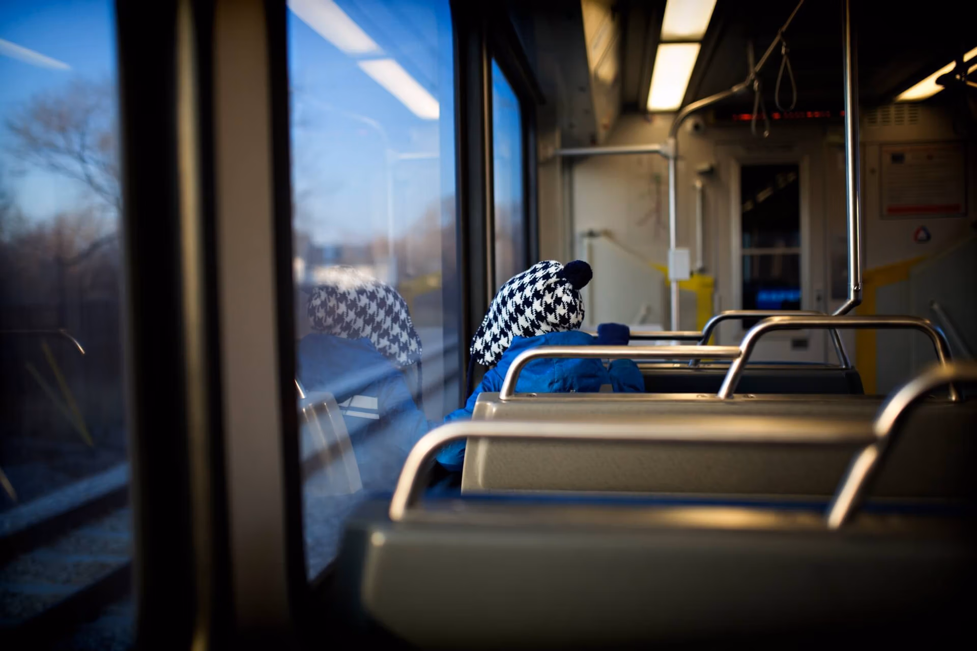 boy sitting on the train and looking out the train window